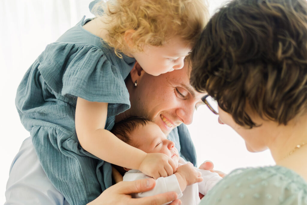 a man and woman holding a baby