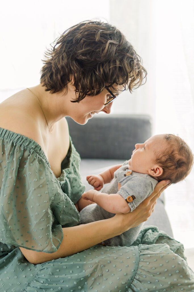 Mom proudly holding her baby boy